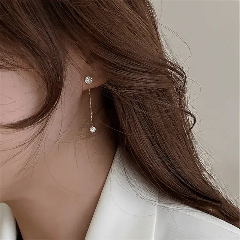 Alvora Delora gold drop earrings with twin solitaire stones on fine chains, minimal design