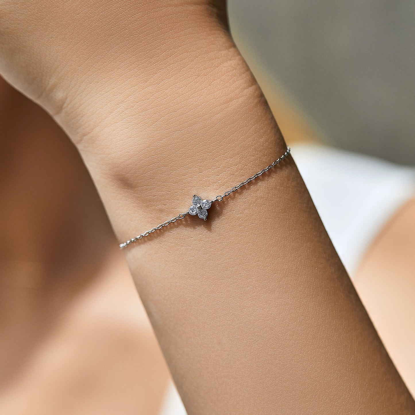 Minimal Silver Bracelet with Diamond FloralDesign on the wrist 