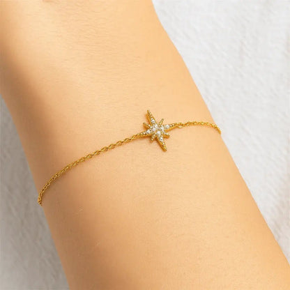 Minimal gold bracelet with star design on a wrist 